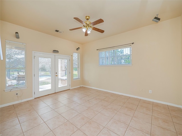 tiled empty room with french doors, ceiling fan, and a wealth of natural light