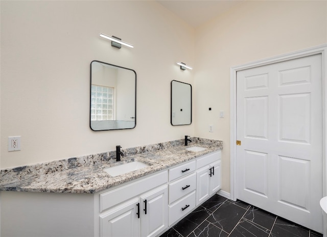 bathroom with tile flooring, large vanity, and dual sinks