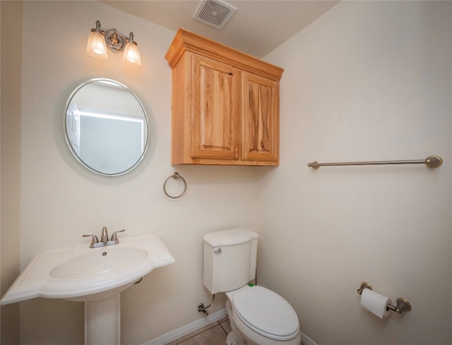 bathroom with tile flooring and toilet