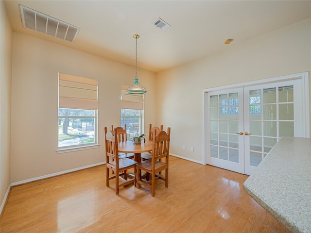 dining area featuring french doors and light hardwood / wood-style flooring