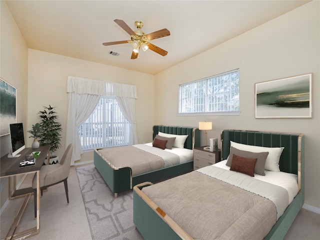 bedroom with light carpet, ceiling fan, and multiple windows