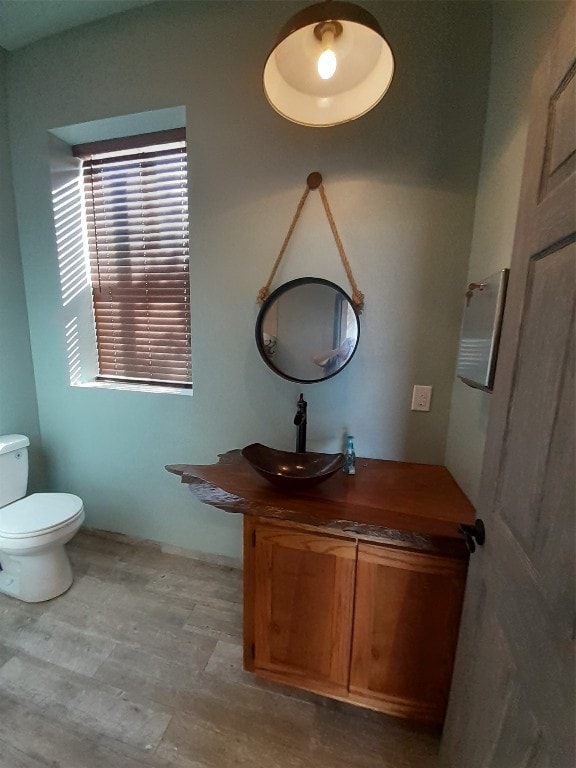 bathroom with vanity, hardwood / wood-style floors, and toilet