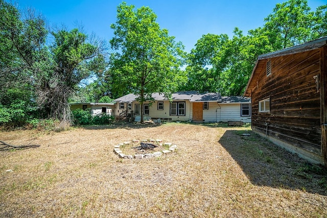 back of house with a lawn