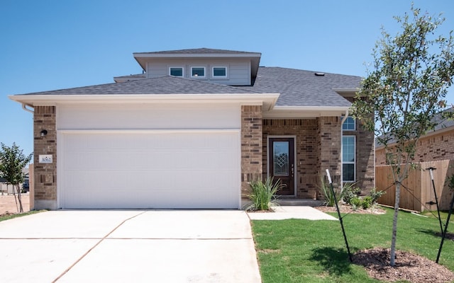 view of front of house with a front yard and a garage