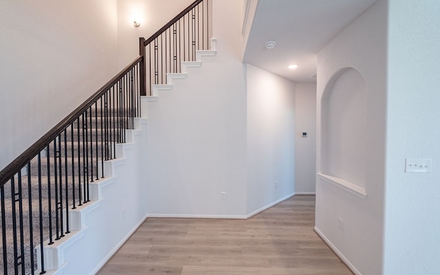 stairway featuring light wood-type flooring