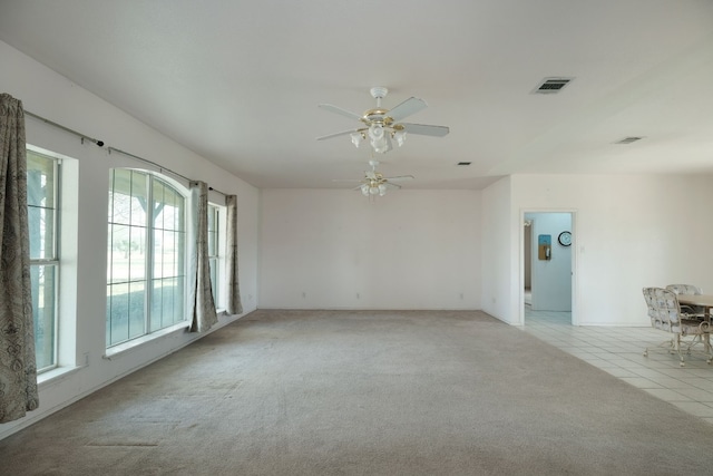 unfurnished room with ceiling fan and light colored carpet