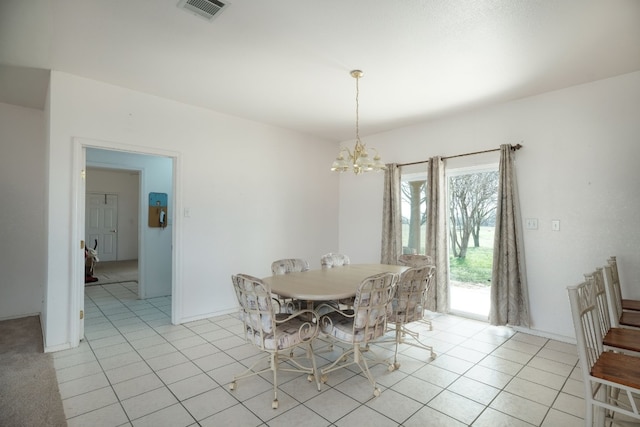 tiled dining space with a chandelier