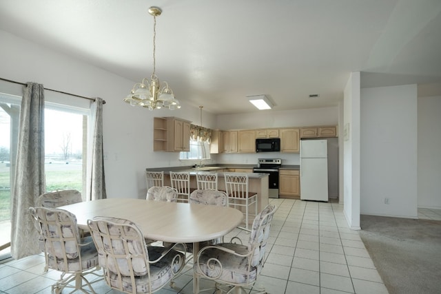 carpeted dining space featuring an inviting chandelier and sink