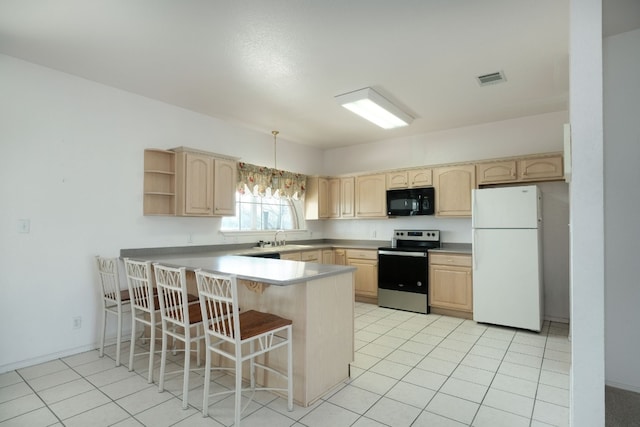 kitchen with light tile flooring, white fridge, decorative light fixtures, a kitchen breakfast bar, and stainless steel electric stove