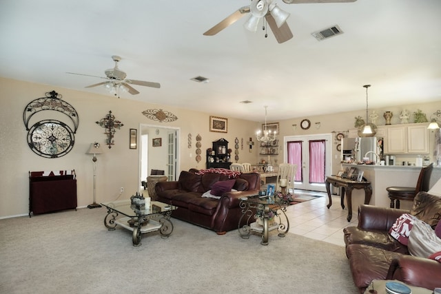 living room with french doors, light carpet, and ceiling fan with notable chandelier