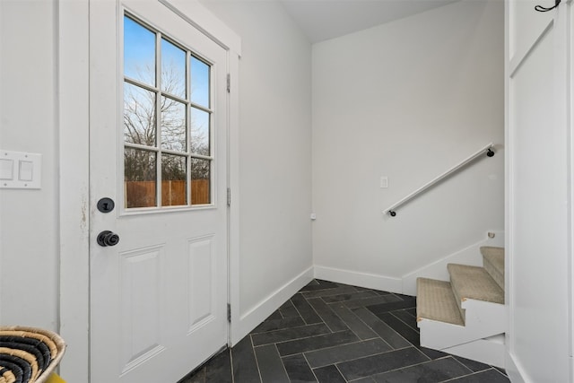 entryway with dark tile floors