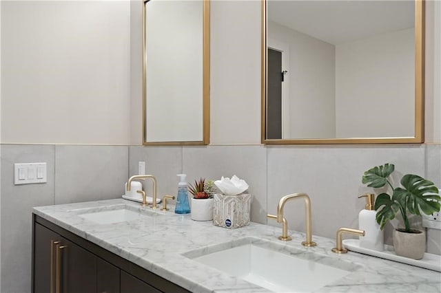 bathroom with vanity with extensive cabinet space and double sink