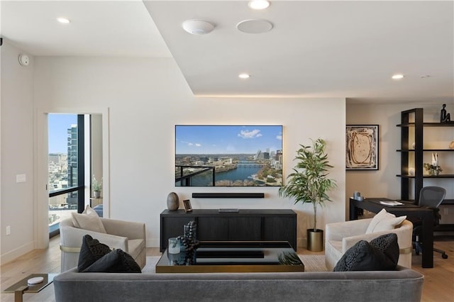 living room with a water view and light wood-type flooring