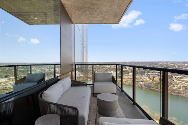 balcony with a water view and an outdoor living space