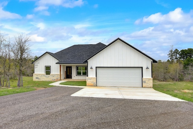 modern farmhouse featuring a front lawn and a garage