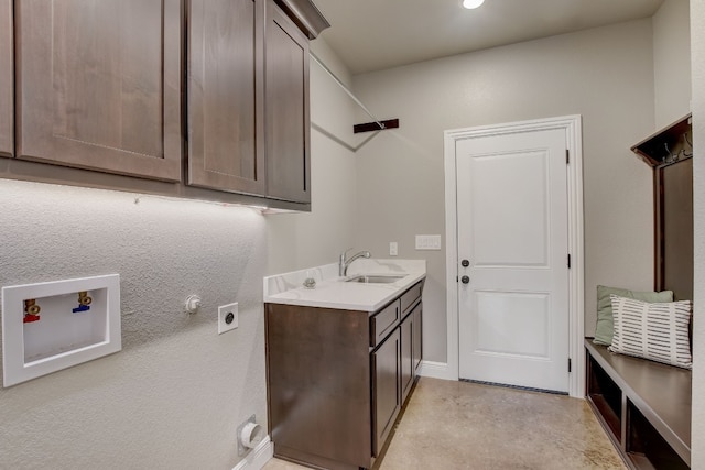 clothes washing area with cabinets, hookup for an electric dryer, sink, and hookup for a washing machine