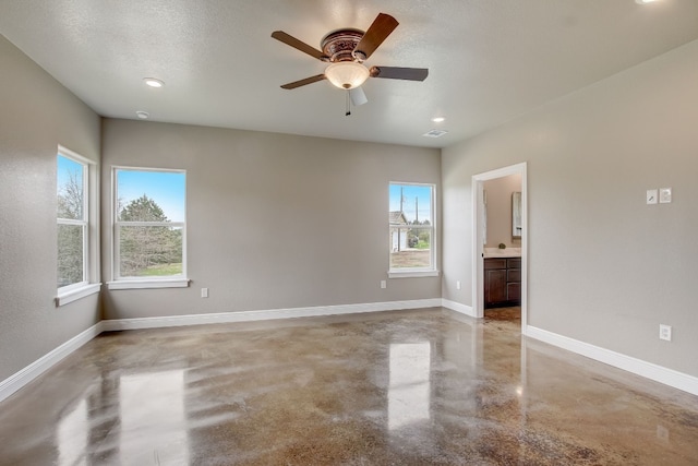 spare room with ceiling fan and a textured ceiling