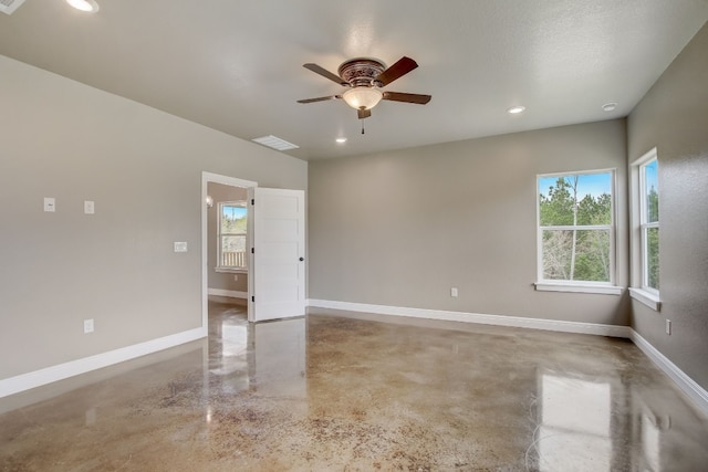 empty room with plenty of natural light, a textured ceiling, and ceiling fan