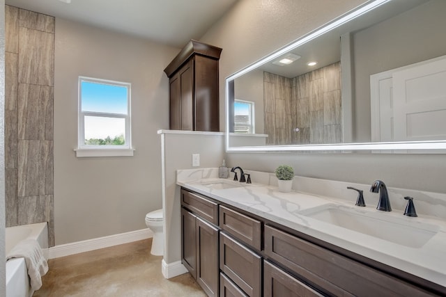 bathroom featuring toilet and dual vanity