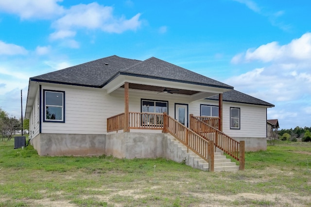 exterior space featuring ceiling fan, central AC unit, and a lawn