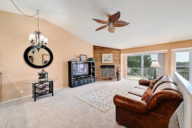 living room featuring wooden walls, light colored carpet, vaulted ceiling, and ceiling fan with notable chandelier