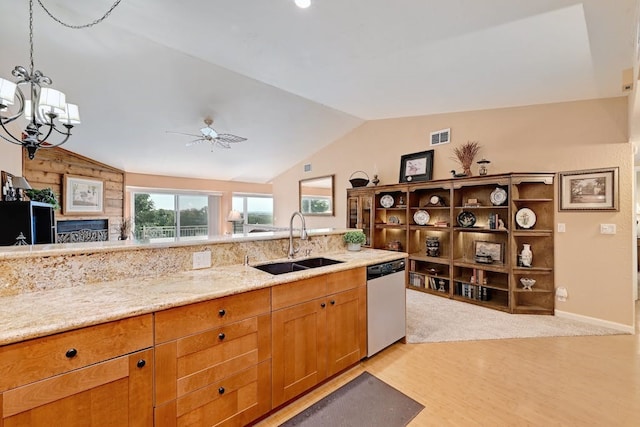 kitchen featuring lofted ceiling, dishwashing machine, sink, and ceiling fan with notable chandelier