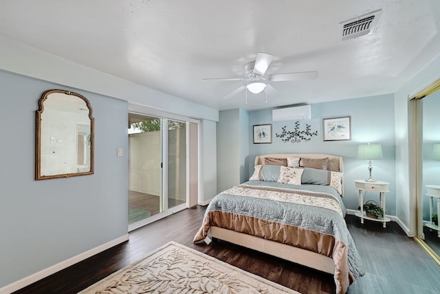 bedroom with an AC wall unit, ceiling fan, and dark hardwood / wood-style flooring