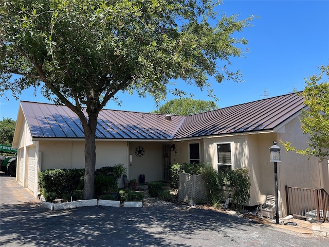 ranch-style home featuring a garage