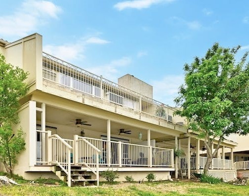 back of property with ceiling fan