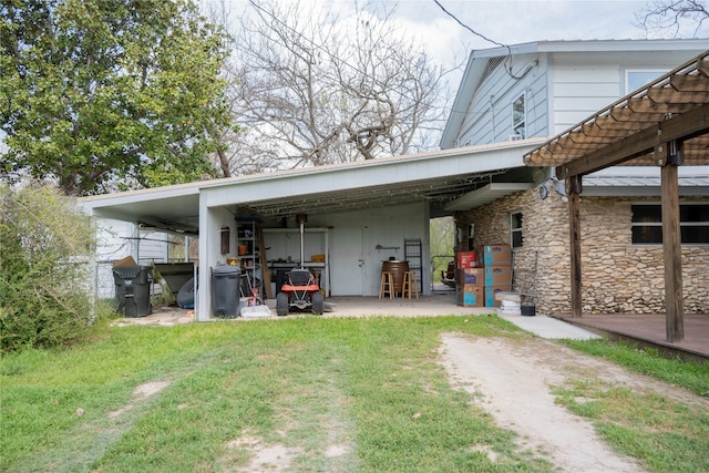 rear view of property featuring a lawn