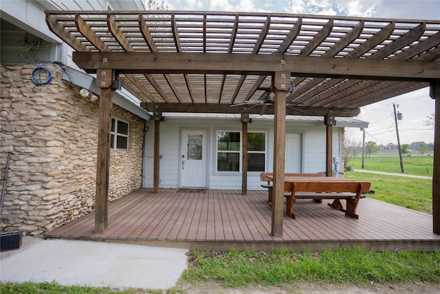 wooden deck with a yard and a pergola