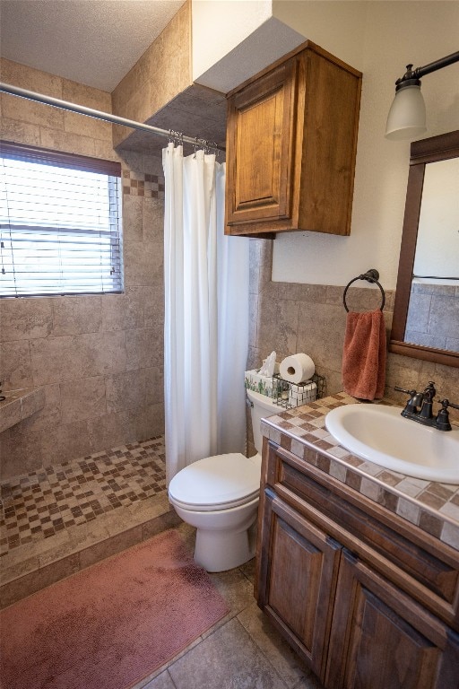 bathroom with tile flooring, large vanity, a textured ceiling, a shower with shower curtain, and toilet