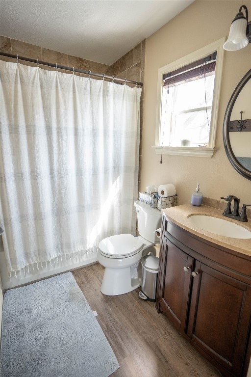 bathroom with vanity, toilet, and hardwood / wood-style flooring