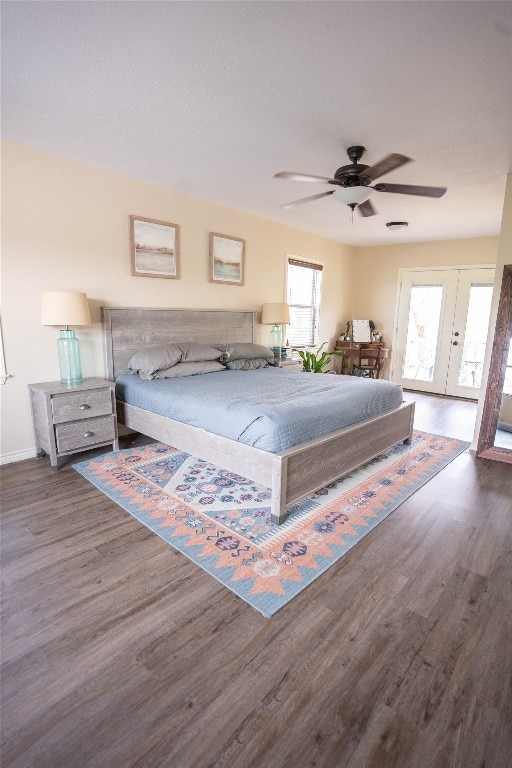 bedroom featuring french doors, ceiling fan, multiple windows, and dark wood-type flooring