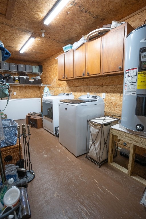 washroom featuring water heater, cabinets, and separate washer and dryer