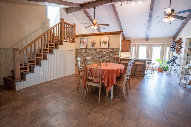 tiled dining room featuring ceiling fan, rail lighting, high vaulted ceiling, and french doors