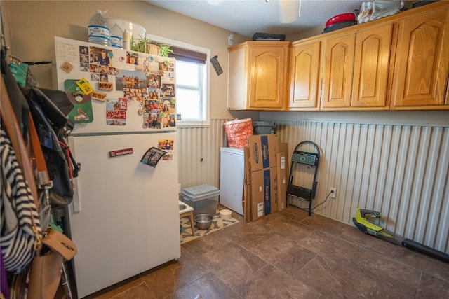 laundry room with dark tile flooring