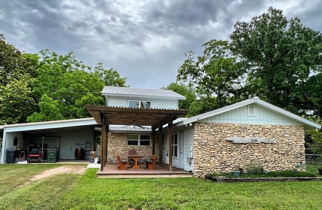 back of property featuring a pergola and a yard