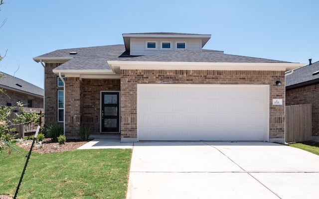 view of front of home with a front lawn and a garage