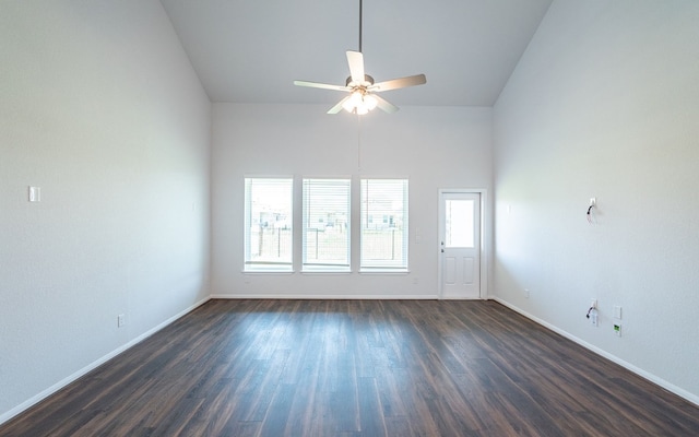 empty room with high vaulted ceiling, dark hardwood / wood-style floors, and ceiling fan