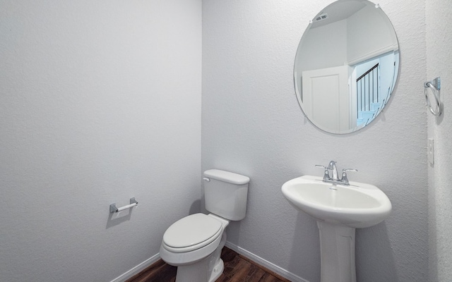 bathroom featuring hardwood / wood-style floors and toilet