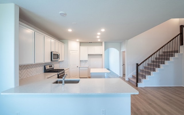 kitchen featuring white cabinetry, light hardwood / wood-style flooring, sink, and stainless steel appliances