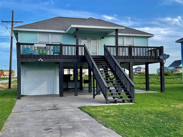 exterior space with a front yard, a garage, and a wooden deck