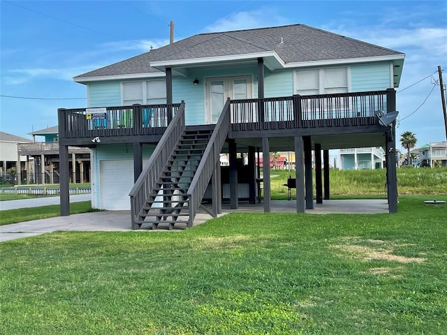 back of property with a lawn and a garage