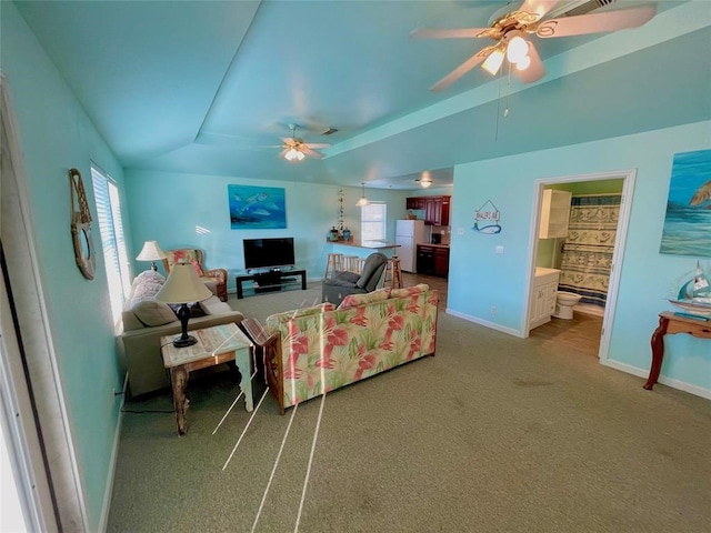 living room with carpet, vaulted ceiling, and ceiling fan