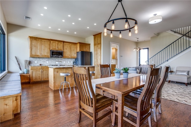 dining area featuring dark hardwood / wood-style flooring and a notable chandelier