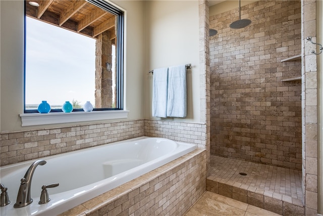 bathroom featuring tile floors and separate shower and tub