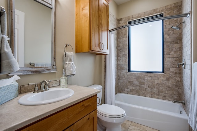 full bathroom with vanity, toilet, tile floors, and tiled shower / bath