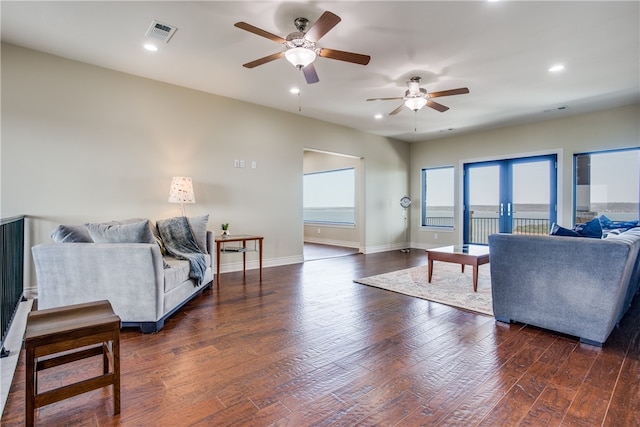 living room with french doors, dark hardwood / wood-style floors, and ceiling fan