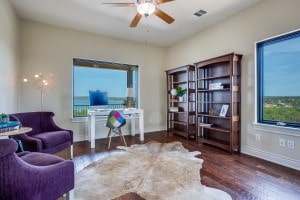 living area with ceiling fan and dark wood-type flooring